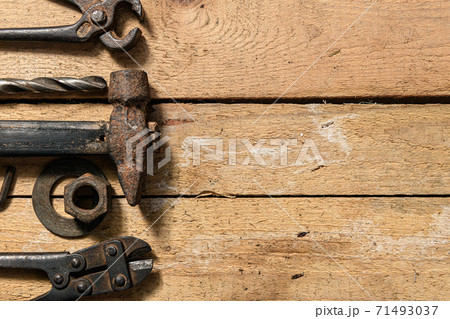 Old vintage household hand tools still life on a wooden background with copyspace and place for text Old vintage household hand tools still life on a wooden background with copyspace and place for text 71493037