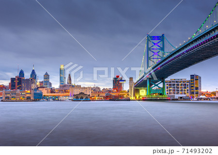 Philadelphia, Pennsylvania, USA skyline on the Delaware river with Ben Franklin Bridge Philadelphia, Pennsylvania, USA skyline on the Delaware river with Ben Franklin Bridge 71493202