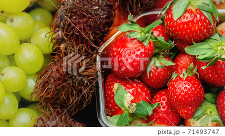 background with healthy fresh fruits grapes lychee strawberry. Close-up background with healthy fresh fruits grapes lychee strawberry. Close-up 71493747