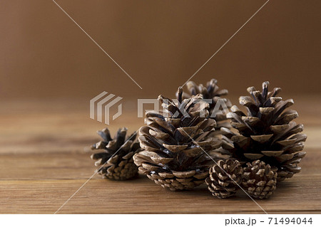 Winter, Christmas background with pine cones over wooden background. 71494044