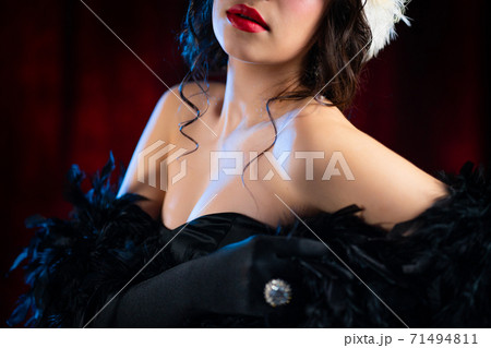 Dress details of unrecognizable woman. Art deco, roaring twenties era - jewelry and bijouterie of Dress details of unrecognizable woman. Art deco, roaring twenties era - jewelry and bijouterie of 71494811
