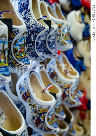 Kinderdijk, The Netherlands, August 2019. Souvenir Dutch clogs, produced in different shapes and colors, make a good show in the display. 71495212