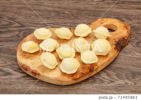 Raw dumplings over board for cooking Raw dumplings over board for cooking 71495863