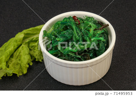 Green Chuka Seaweed Salad Isolated on White Background Top View. Wakame Sea Kelp Salat Green Chuka Seaweed Salad Isolated on White Background Top View. Wakame Sea Kelp Salat 71495953