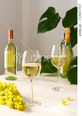 Two glasses with white wine and a bottle Two glasses with white wine and a bottle 71497757