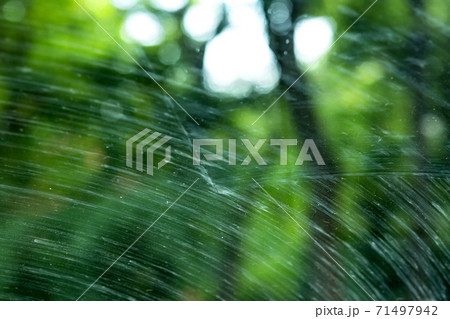 windshield of a dirty car in mud smeared by car wipers close up. 71497942