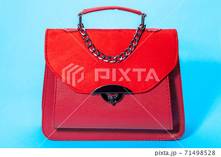 women's handbag in red leather and suede, object on a blue background. 71498528