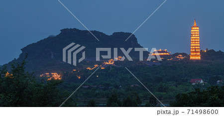 Bai Dinh Pagoda at twilight, Ninh Binh, the biggest buddhist temple complex in Vietnam, tourist religious travel destination. Scenic karst landscape. Bai Dinh Pagoda at twilight, Ninh Binh, the biggest buddhist temple complex in Vietnam, tourist religious travel destination. Scenic karst landscape. 71498600