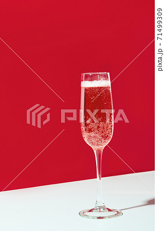 Wineglass of champagne on red  71499309