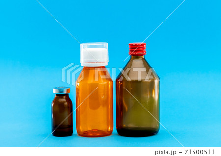 jar with medical disinfectants and a glass bottle for health treatment, pharmacy objects on a blue background with a copy space. jar with medical disinfectants and a glass bottle for health treatment, pharmacy objects on a blue background with a copy space. 71500511