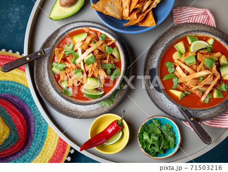 Mexican style table with spicy aztec soup with tortilla. Copy space 71503216