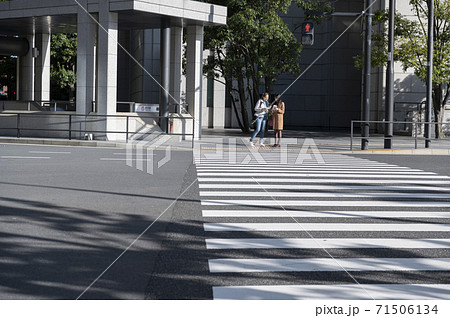 交差点で信号待ちしてる時に外国人女性に道を聞かれる日本人女性 71506134