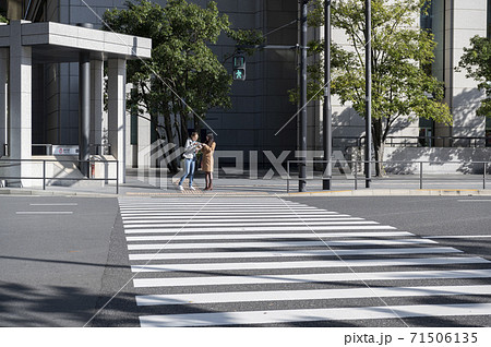 交差点で信号待ちしてる時に外国人女性に道を聞かれる日本人女性 71506135