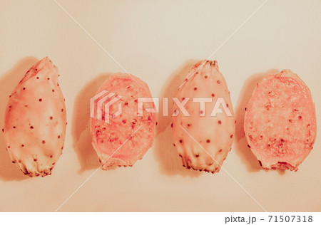 Fichi di India, cactus fig fruits or prickly pear of Opuntia, fresh ripe figs in a row in pastel colors 71507318