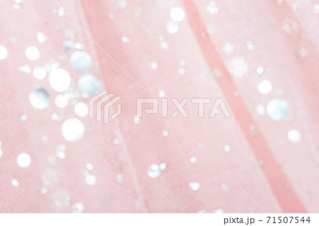 Pink tulle fabric with sequins as background and texture, close-up 71507544