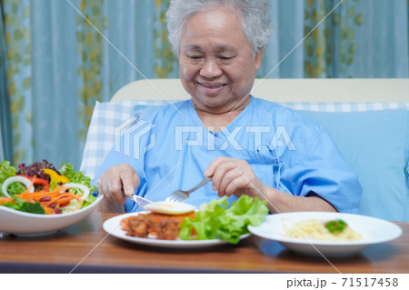 Asian senior or elderly old lady woman patient eating breakfast vegetable healthy food Asian senior or elderly old lady woman patient eating breakfast vegetable healthy food 71517458