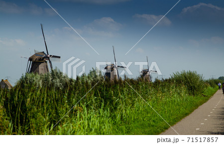 Kinderdijk, The Netherlands, August 2019. On a beautiful summer day the typical landscape of the place Kinderdijk, The Netherlands, August 2019. On a beautiful summer day the typical landscape of the place 71517857