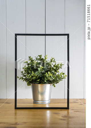 A blank black frame  and a flowerpot 71518661