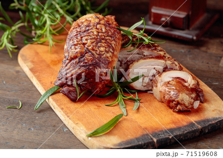 Smoked chicken thighs with rosemary on a cutting board. Smoked chicken thighs with rosemary on a cutting board. 71519608