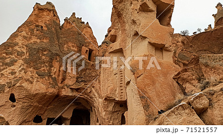 Cave houses and monasteries carved into Tufa Rocks at Zelve Open Air Museum (Zelve Valley) in winter season in Cappadocia, Turkey Cave houses and monasteries carved into Tufa Rocks at Zelve Open Air Museum (Zelve Valley) in winter season in Cappadocia, Turkey 71521557