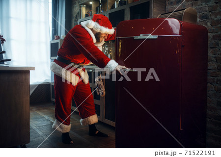 Bad impudent Santa claus opens the refrigerator Bad impudent Santa claus opens the refrigerator 71522191