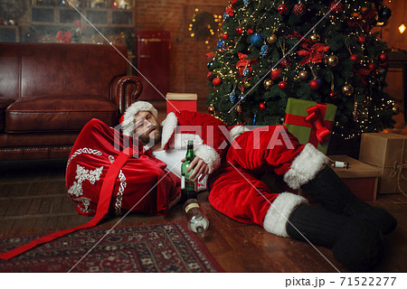 Bad drunk Santa claus sleeps under christmas tree 71522277