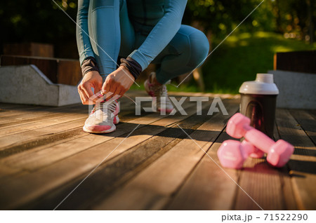 Workout in park, smiling woman in headphones Workout in park, smiling woman in headphones 71522290