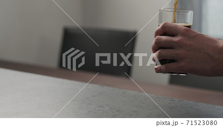 Slow motion man pour cola into highball glass on concrete countertop with copy space Slow motion man pour cola into highball glass on concrete countertop with copy space 71523080