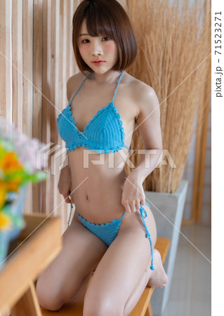 Portrait of young pretty sexy Asian woman wearing blue bikini in her room. Portrait of young pretty sexy Asian woman wearing blue bikini in her room. 71523271