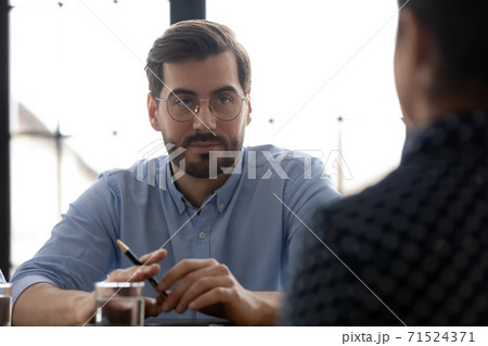 Confident male hr thinking of hiring job candidate Confident male hr thinking of hiring job candidate 71524371