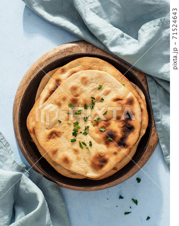 naan flatbread on blue, copy space, top view naan flatbread on blue, copy space, top view 71524643