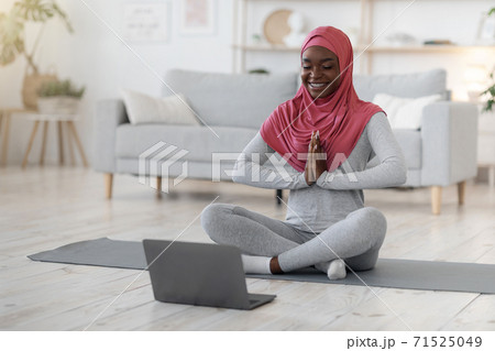 Home Training. Black Muslim Lady In Hijab Meditating In Front Of Laptop 71525049