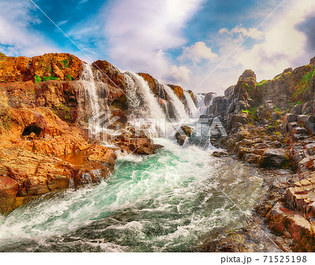 Charming view of Kolufossar waterfall at summer sunny day. Charming view of Kolufossar waterfall at summer sunny day. 71525198