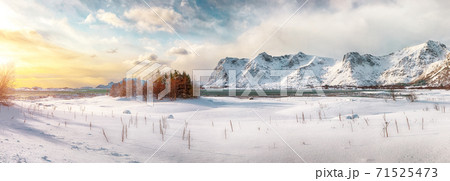 Winter scenery with frozen fjord on Vestvagoy island at sunset with snowy  mountain peaks 71525473