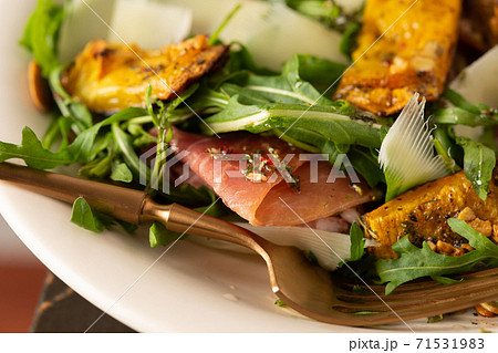 Salad with arugula, pumpkin, prosciutto and parmesan Salad with arugula, pumpkin, prosciutto and parmesan 71531983