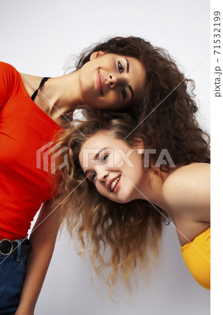 young pretty teenage girls friends with blond and brunette curly hairs posing cheerful isolated on white background, lifestyle people concept 71532199