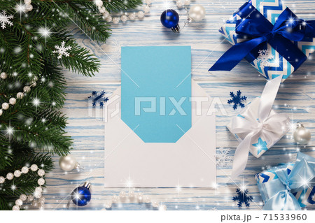 Mockup Christmas greeting card and gifts on blue wooden background. Mockup Christmas greeting card and gifts on blue wooden background. 71533960