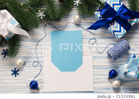 Mockup Christmas greeting card and gifts on blue wooden background. Mockup Christmas greeting card and gifts on blue wooden background. 71533961