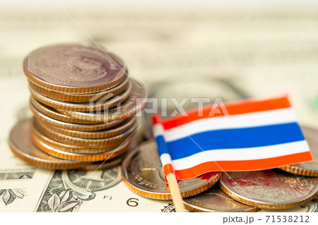 Stack of coins with Thailand flag on USA America dollar banknotes. Stack of coins with Thailand flag on USA America dollar banknotes. 71538212
