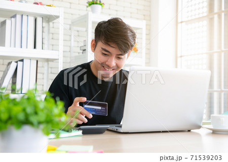 A man paying for online shopping using laptop and credit card. This image is illustrated the online payment concept via smartphone. 71539203