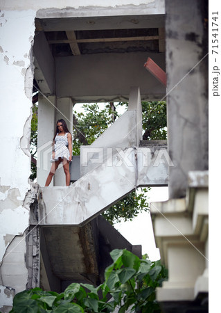 Young model posing in the ruined building Young model posing in the ruined building 71541741
