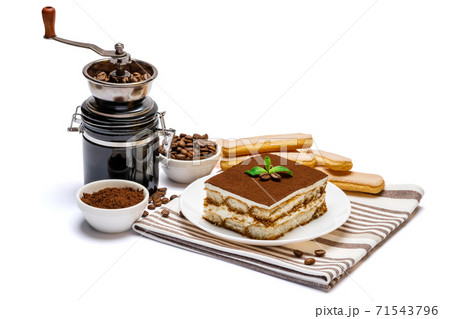 Traditional Italian Tiramisu dessert square portion on ceramic plate, coffee mill grinder and savoiardi cookies a isolated on white background with clipping path 71543796