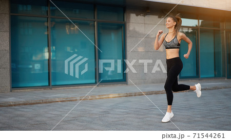 Woman running urban city street background 71544261