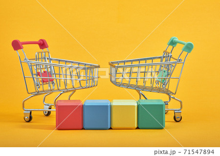 empty wooden cubes mockup style, copy space with shopping trolleys on yellow background. Colourful blocks template for creative design, place for text empty wooden cubes mockup style, copy space with shopping trolleys on yellow background. Colourful blocks template for creative design, place for text 71547894