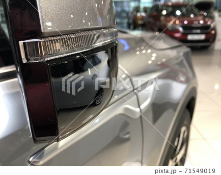 Wing mirror of a brand new car in the dealership, close-up shot 71549019