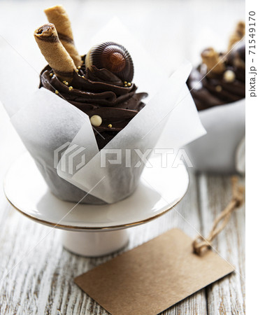 Chocolate cupcakes on white wooden background Chocolate cupcakes on white wooden background 71549170