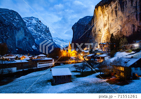 amazing touristic alpine village at night in winter with famous church and Staubbach waterfall  Lauterbrunnen  Switzerland  Europe 71551261