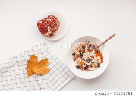 Carbohydrate healthy breakfast. Oatmeal with dried fruits on a white plate. View from above Carbohydrate healthy breakfast. Oatmeal with dried fruits on a white plate. View from above 71551761