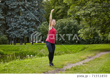Active white woman trains in city garden for healthy near pond. Active white woman trains in city garden for healthy near pond. 71551850