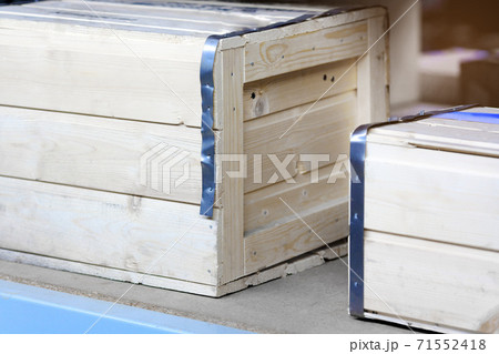 Wooden boxes made of planks are on the shelf of the warehouse. Packaging with copy space. 71552418